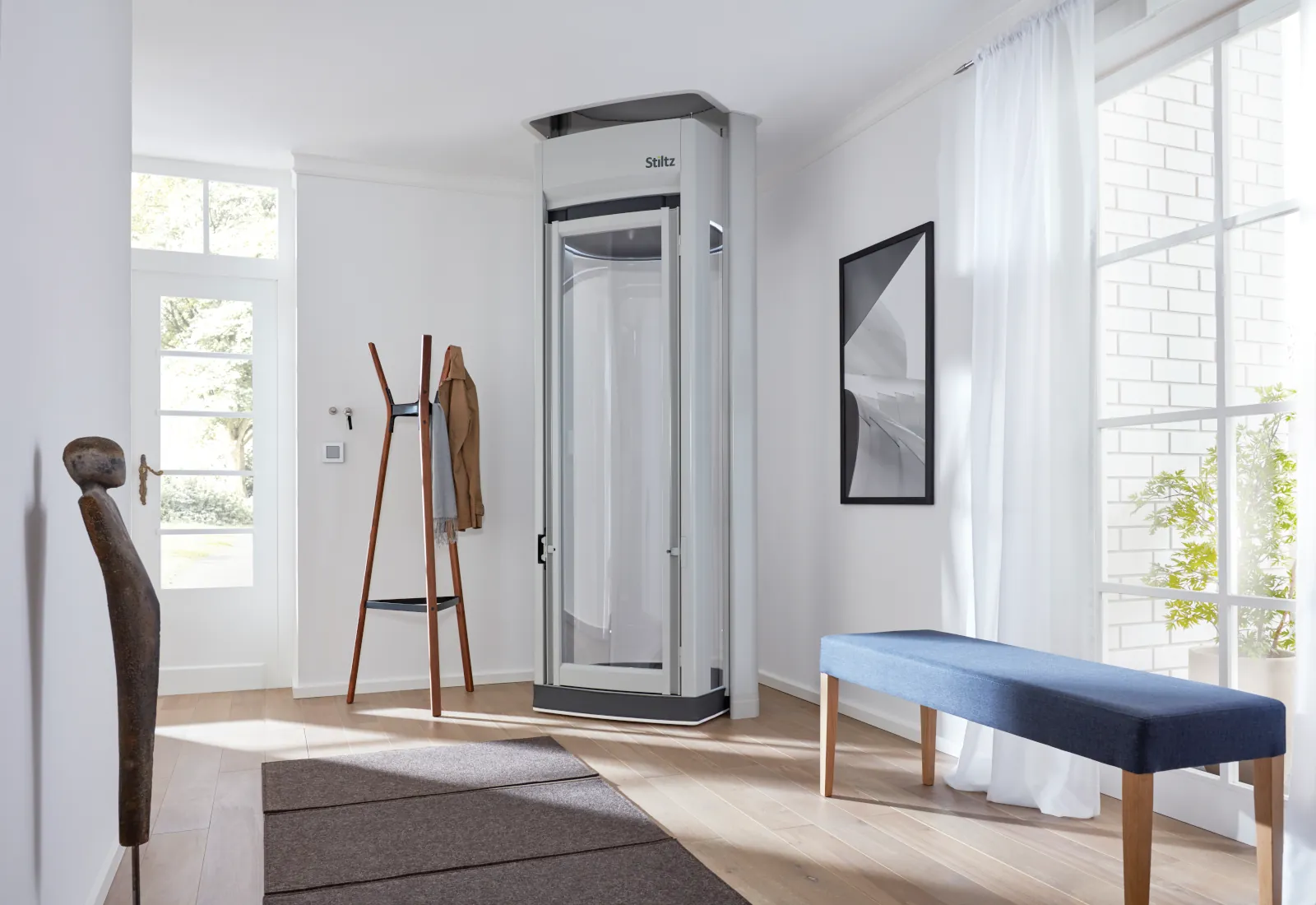 Stiltz homelift installed elegantly in a modern home, showing the compact footprint and glass cabin design